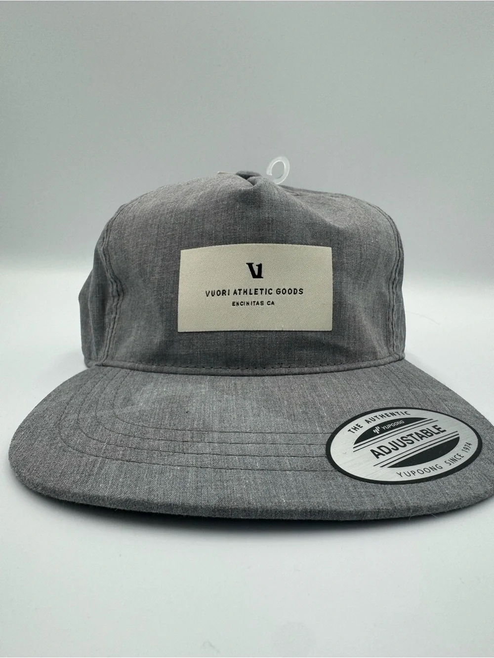 Vuori Gray Five-Panel Adjustable Cap/ Front Patch with faint camo design on brim